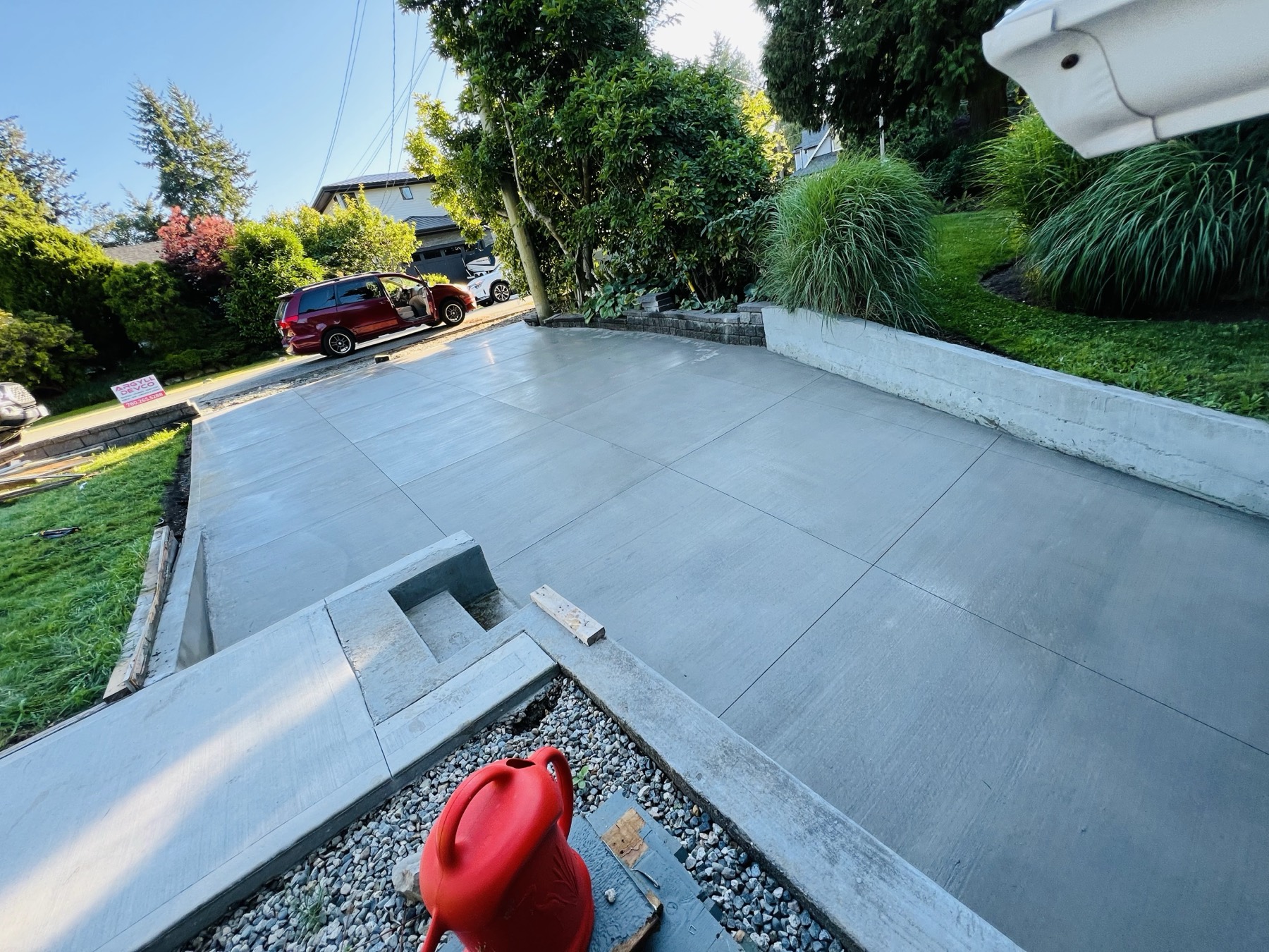 Large finished patio slab with a garden bed behind it