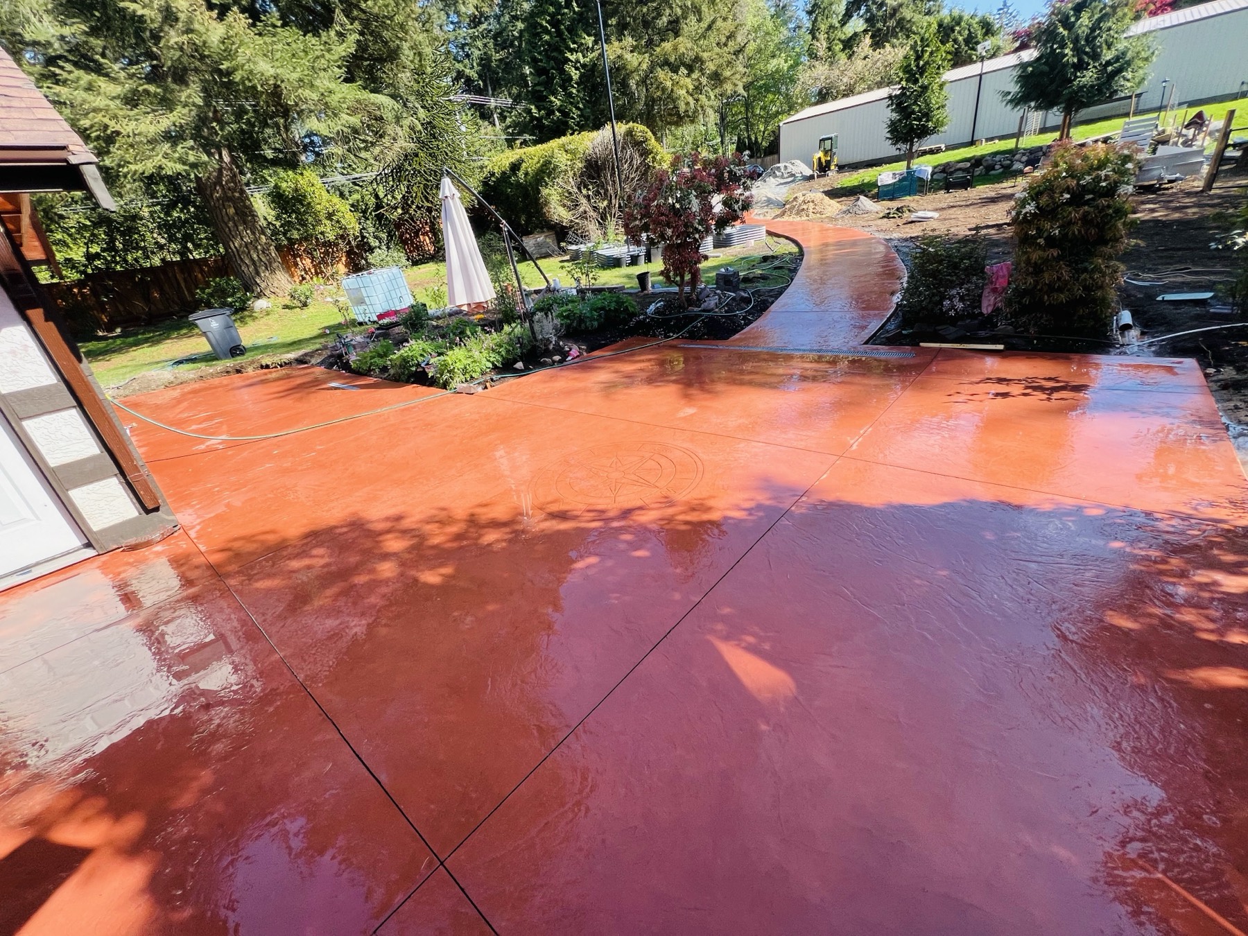 Tinted concrete pathway curving through a planted garden