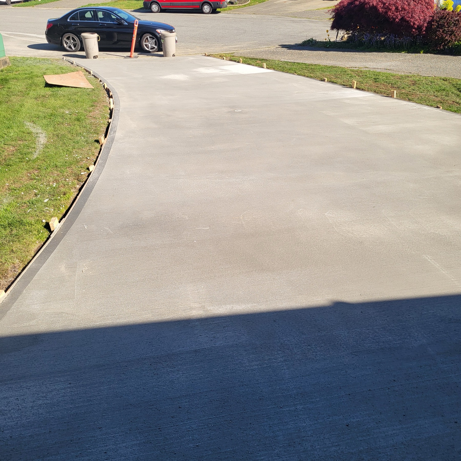 Wide finished residential driveway running out to the street